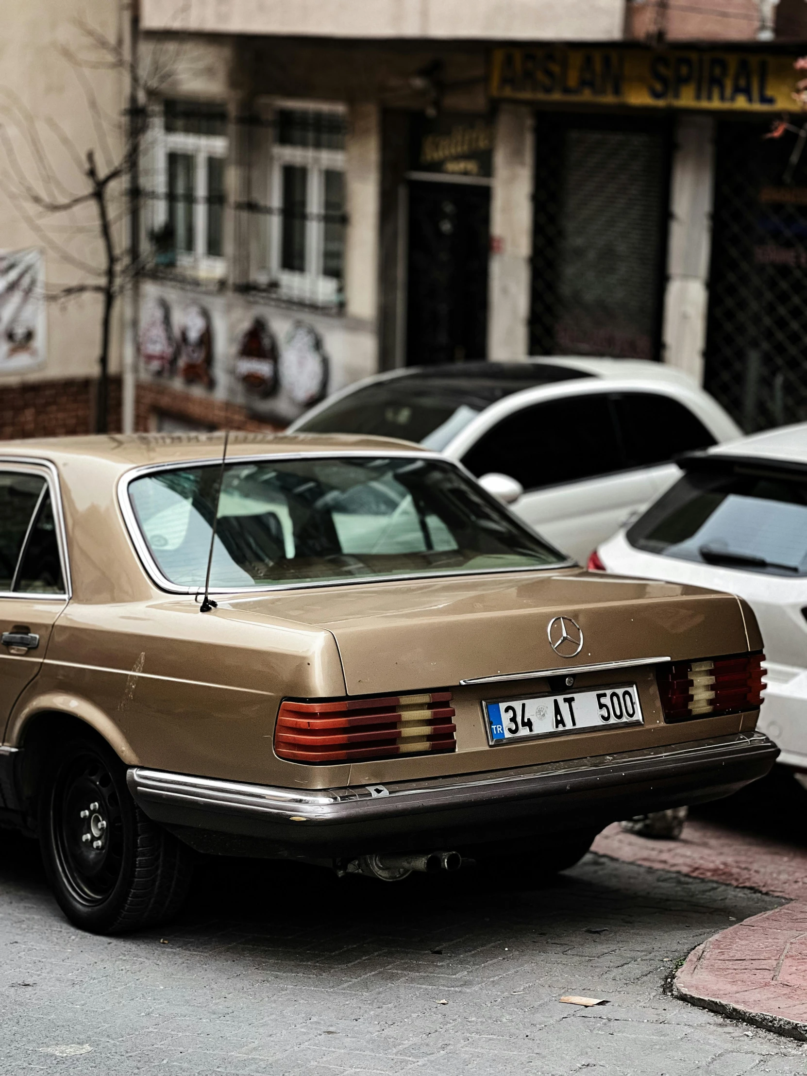 cars parked on a side walk in the city