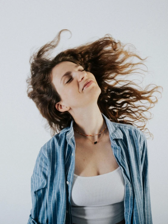 an image of a woman that is holding her head in the air