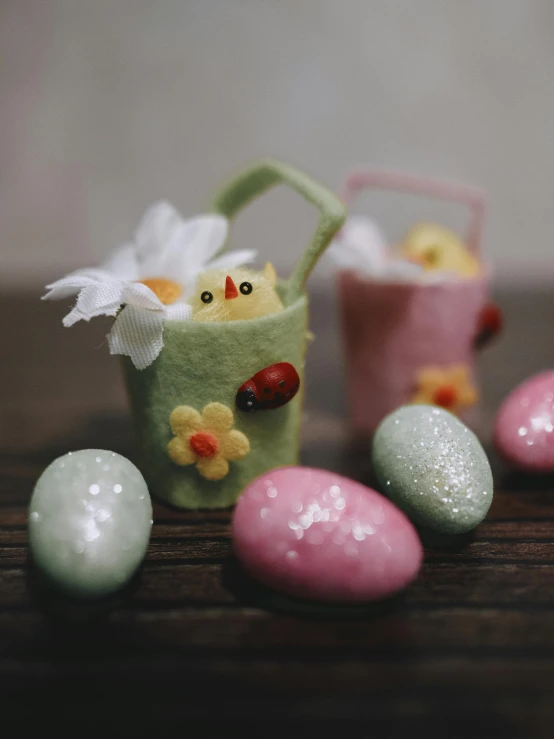 a table with three easter eggs and some little chicks