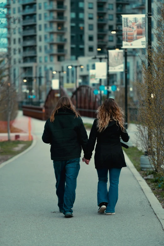 two women walking down the street in the city