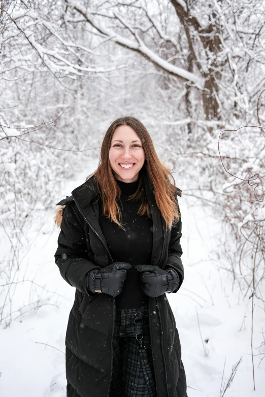 young woman in black jacket and winter snow