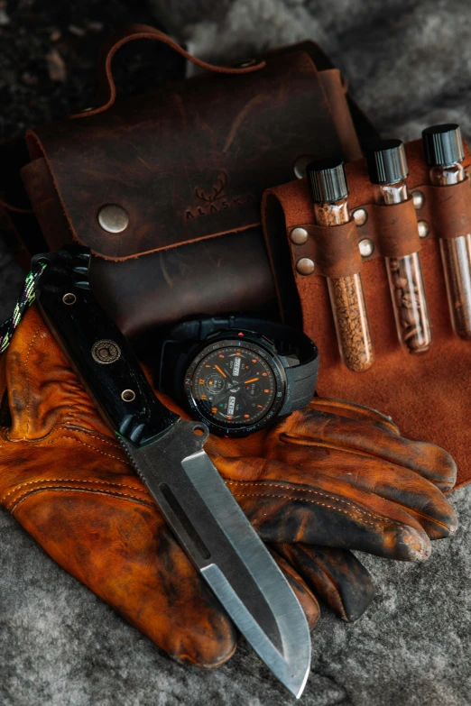 some brown leather and black watches are on the counter