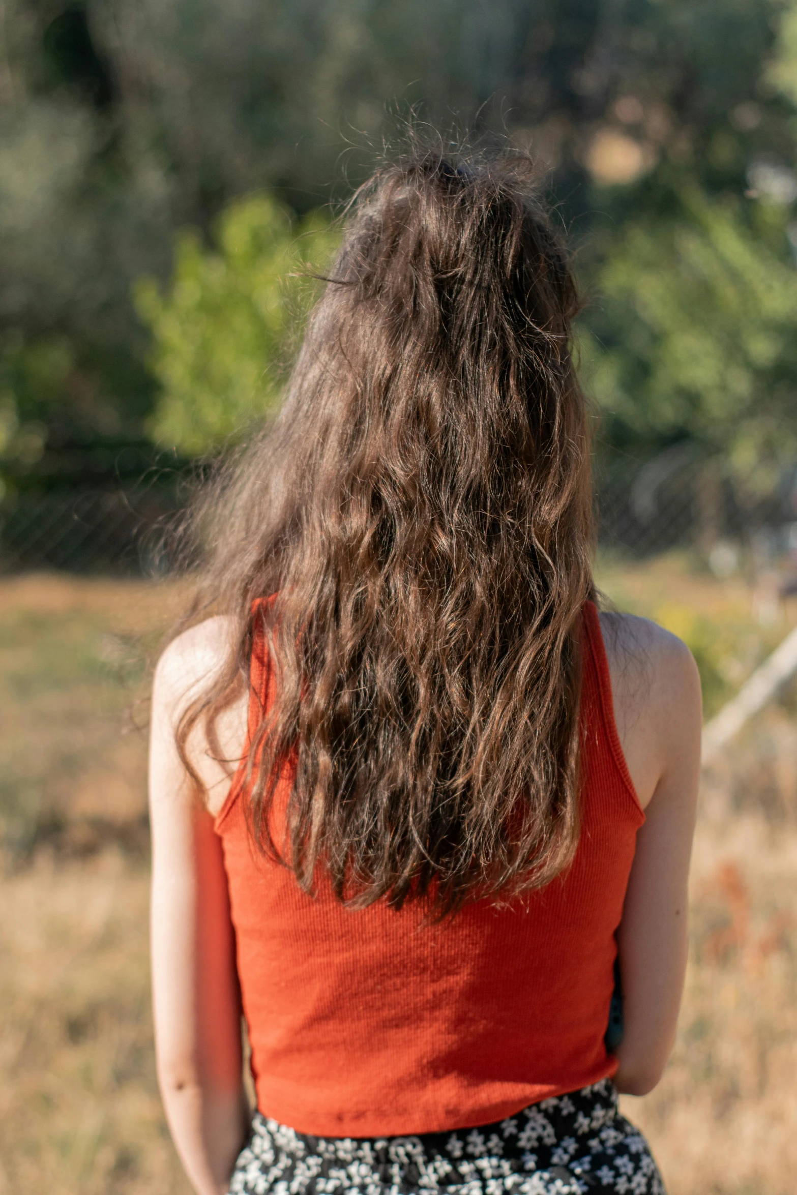 a woman in a dress looking to the sky