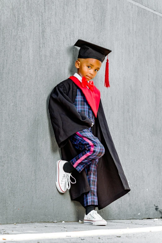 the young child dressed in his own graduation robes