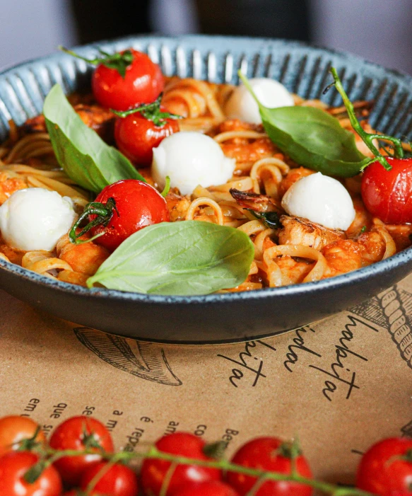 a dish of pasta and cherry tomatoes on a plate