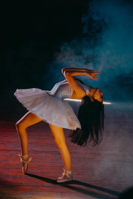 a beautiful woman dancer posing with her arms extended