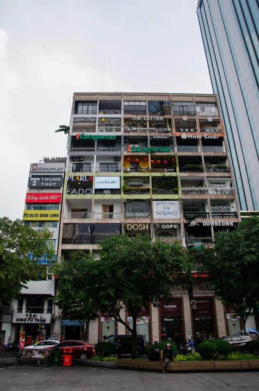 a tall multi - story building with balconies and balconies on the windows