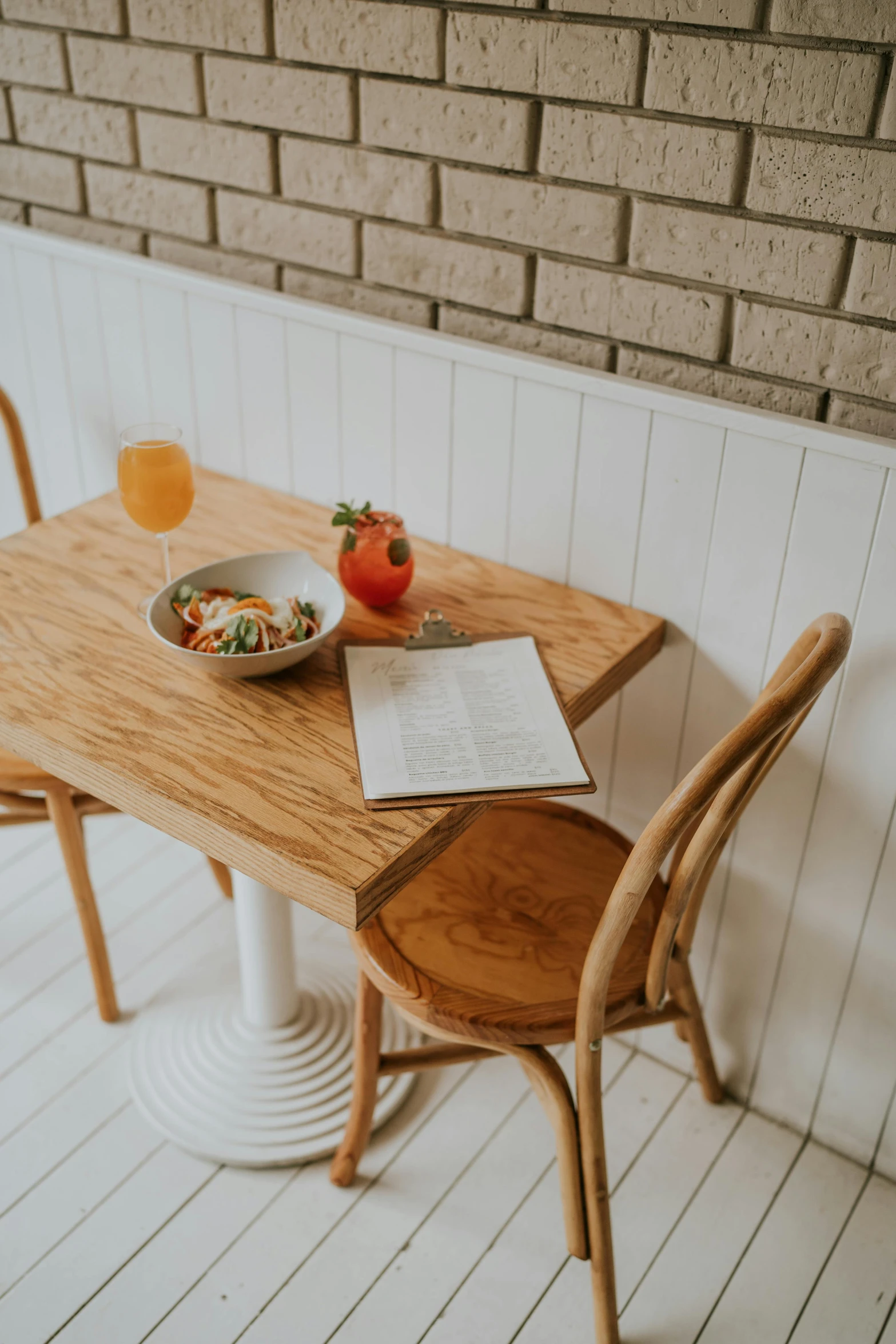 the table with the food is empty next to the book