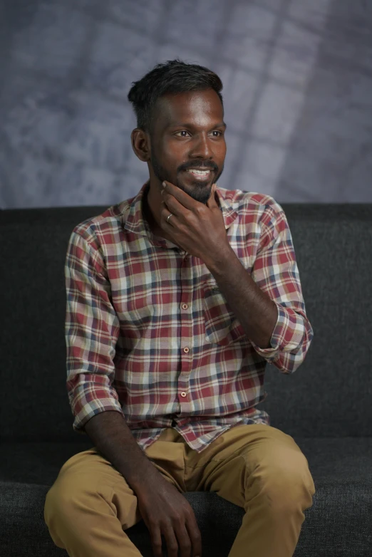 a man sitting on top of a couch