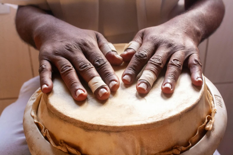 a drummer with the hands on top of a drum