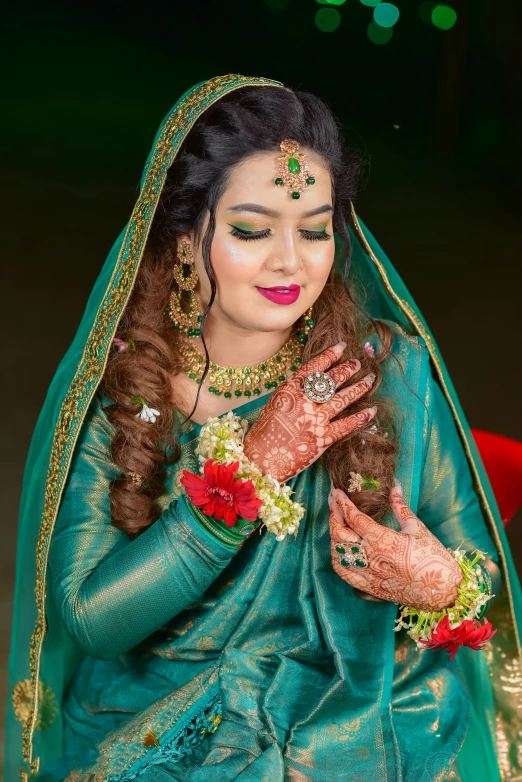 a woman is dressed up in green and yellow with red flowers