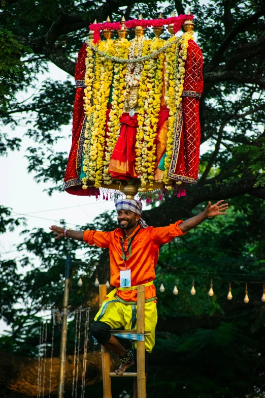 an indian man with a large amount of garland hanging on his head