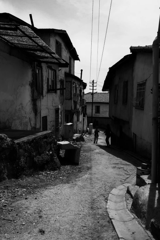 the person is walking by a old street