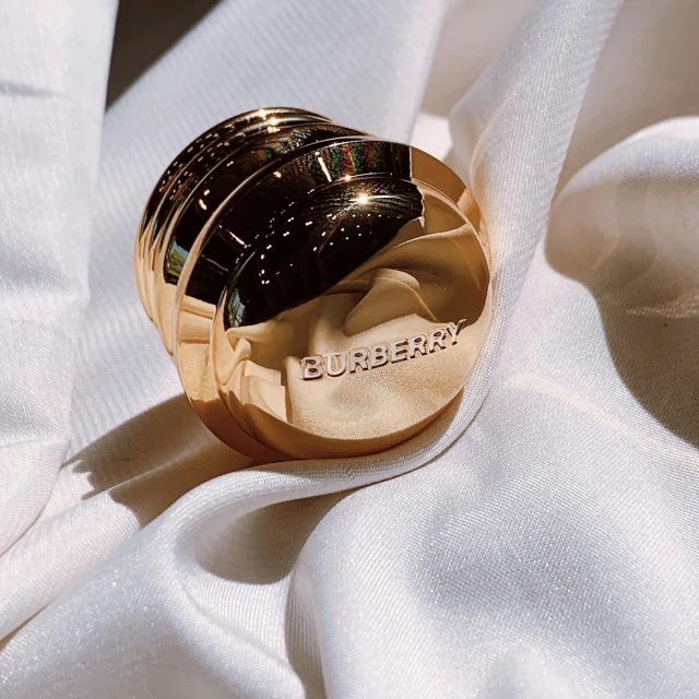 a gold ring sitting on a white cloth