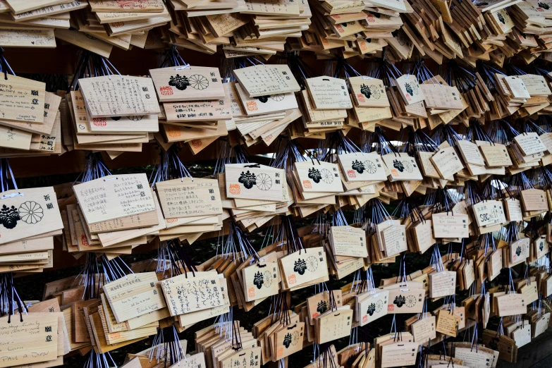a wall with many small wooden tags hanging from them