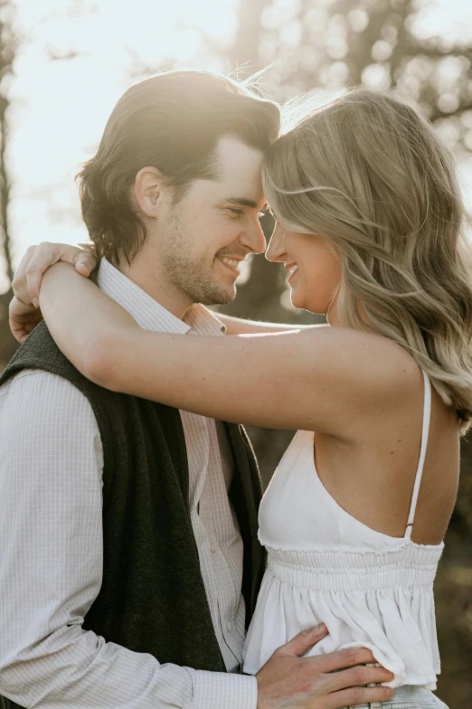 a couple in love hugging each other at sunset