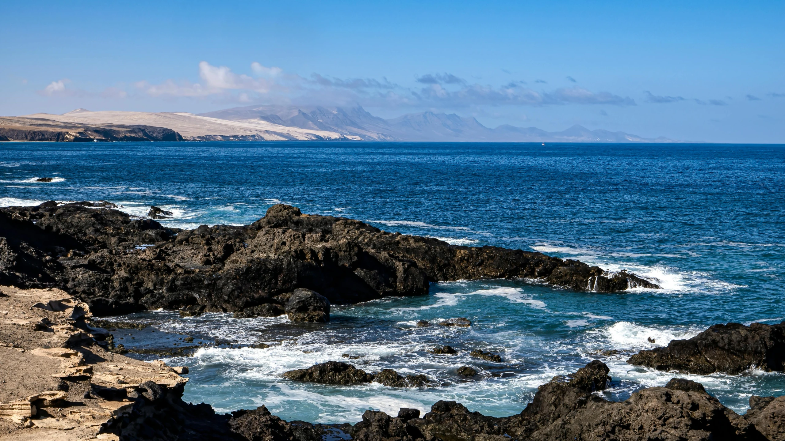 the view from the rocky shore of the ocean