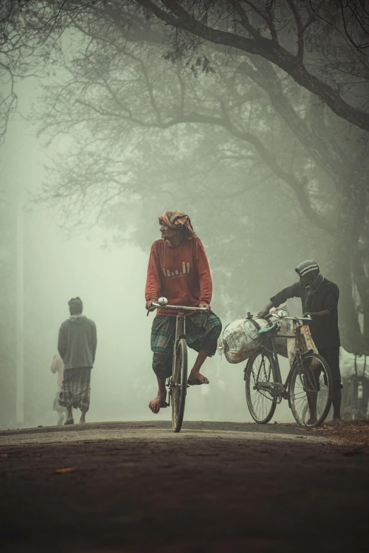 people riding bikes under a cloudy sky in the rain