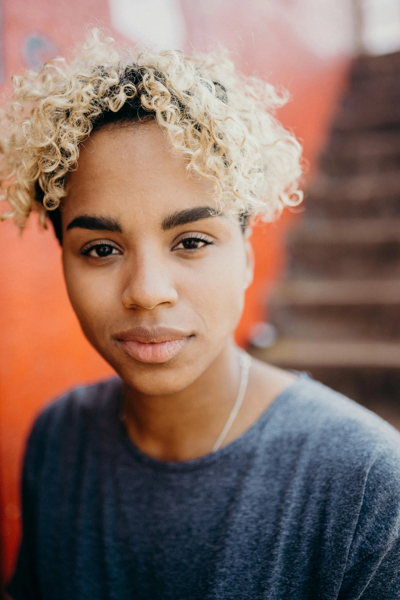 a woman with blond hair looking directly into the camera