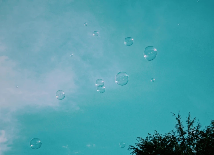 an image of bubbles that are floating in the sky