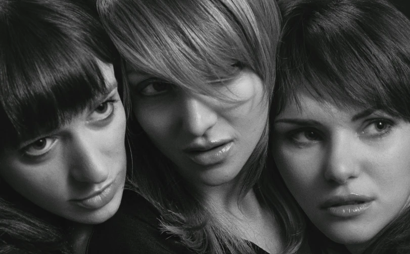 three women are posed for a po together