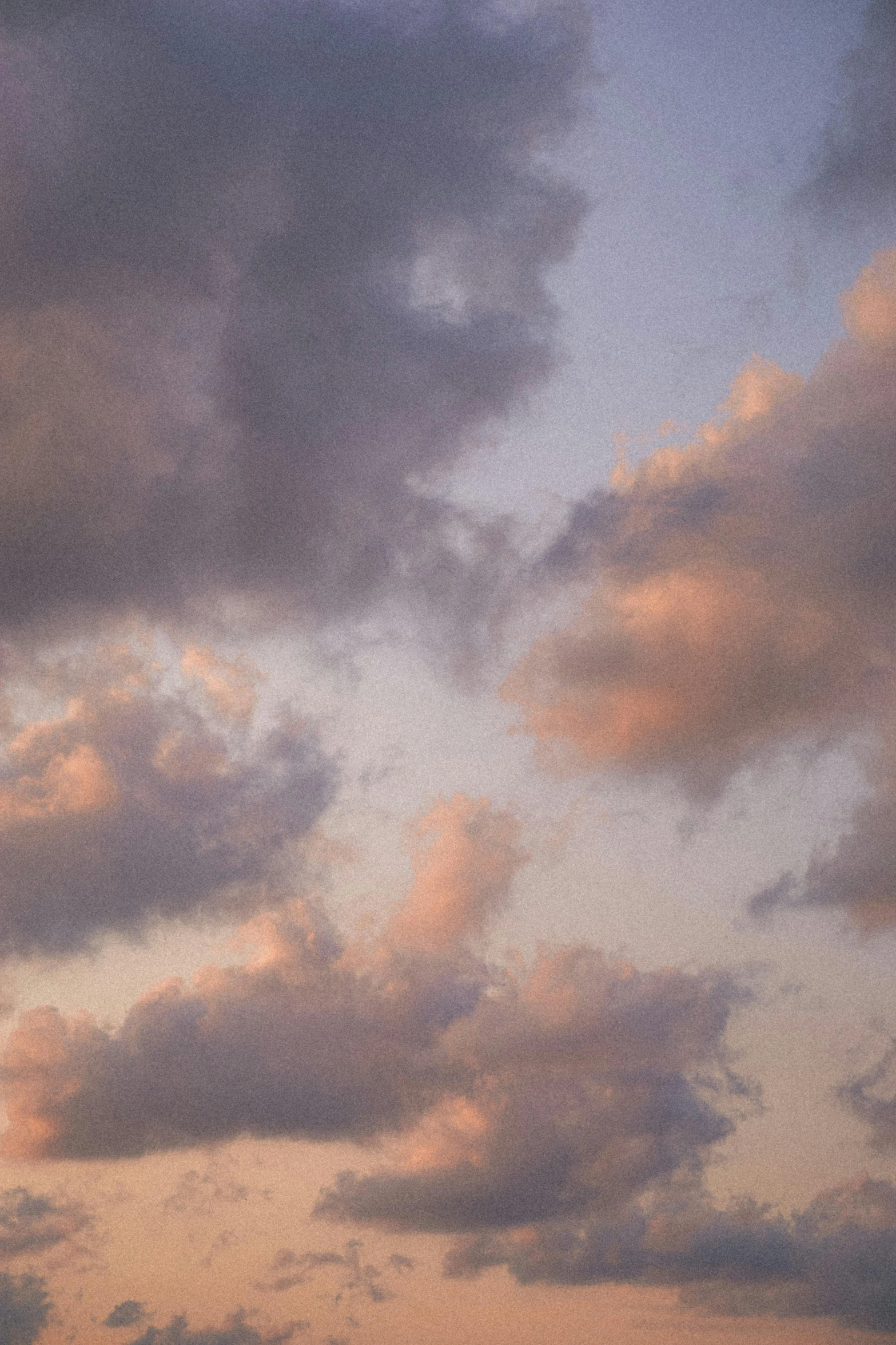 a plane flying through a cloudy sky with a rainbow