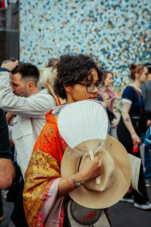 a woman with an umbrella and a large white fan