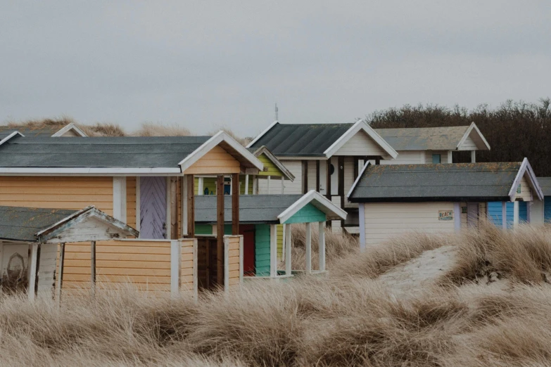 a group of wooden houses sitting on top of a beach