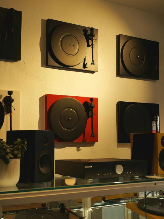 a row of old record players sitting on display