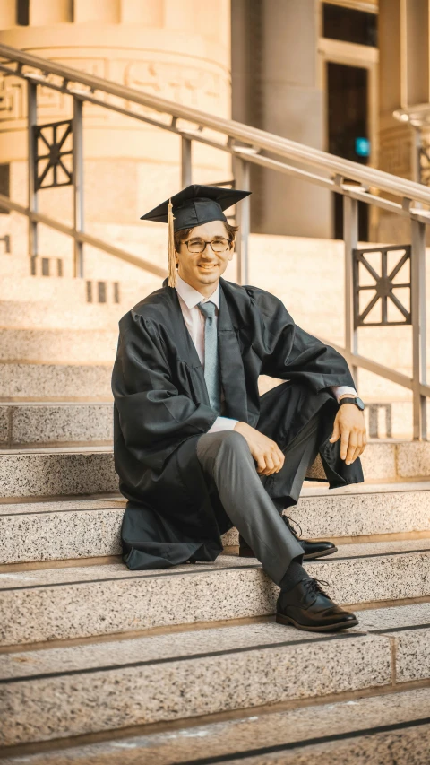 a man sits on some steps wearing a suit and tie