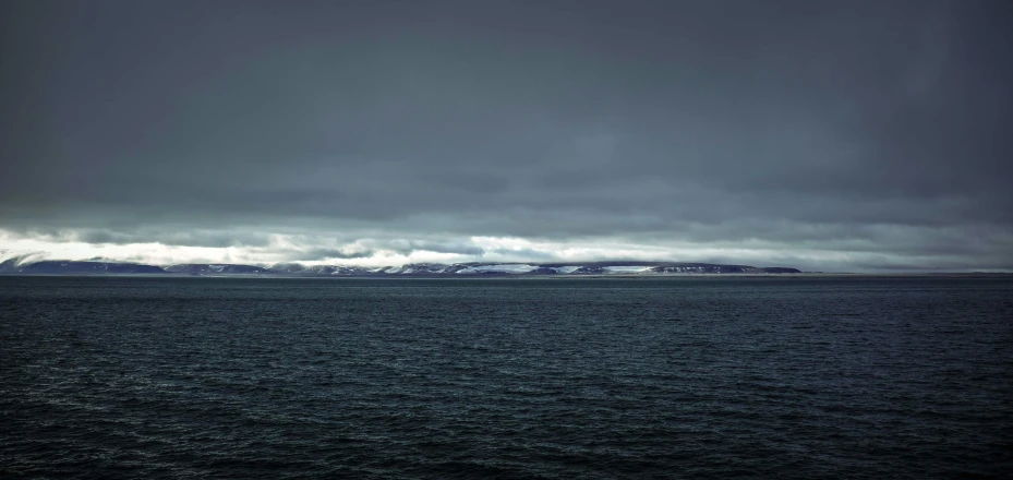 a large body of water under a dark sky