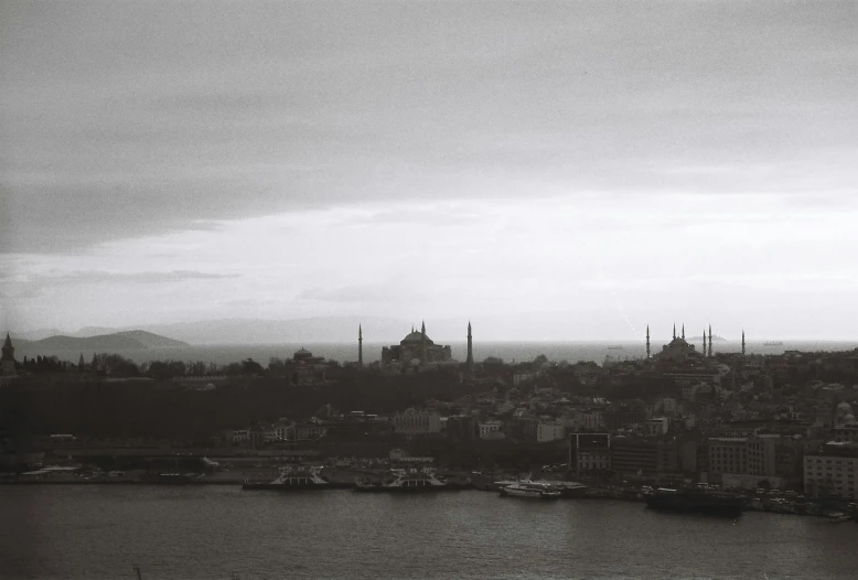 a cloudy view of an area with tall buildings and the ocean