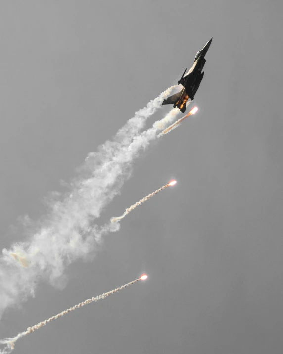 two jets fly side by side through a cloudy sky