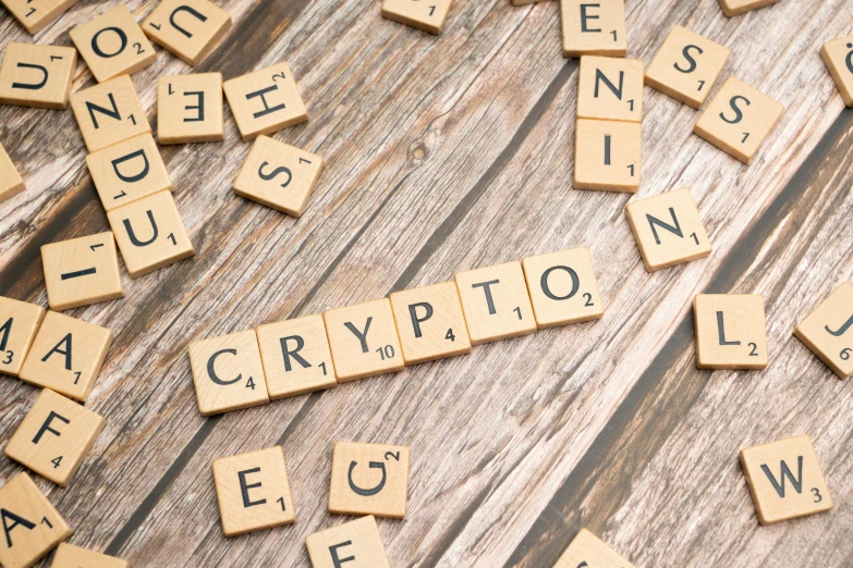 a wooden typewriter letter spelling the word crypt