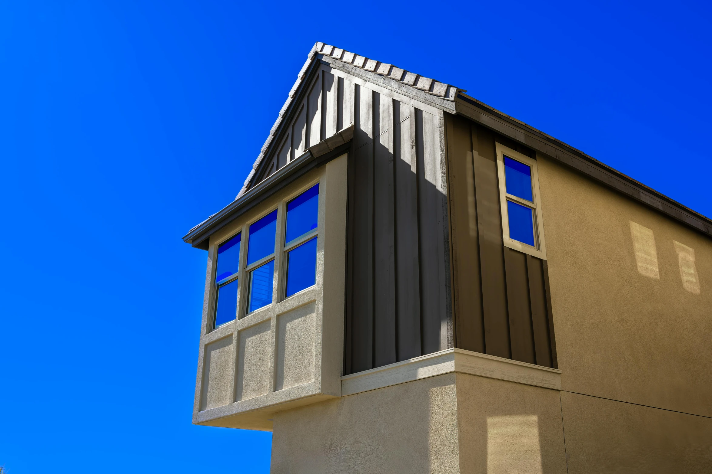 there is a roof with a window and sky behind it