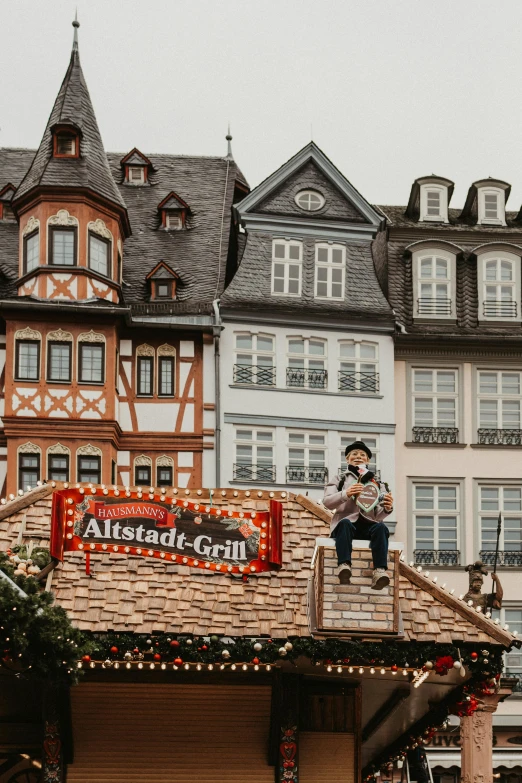 a man is sitting on top of a building