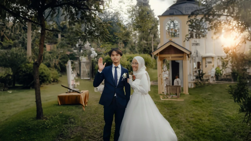 a man and woman in a wedding suit holding hands in front of their home