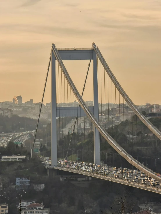 a suspension bridge with cars traveling across it