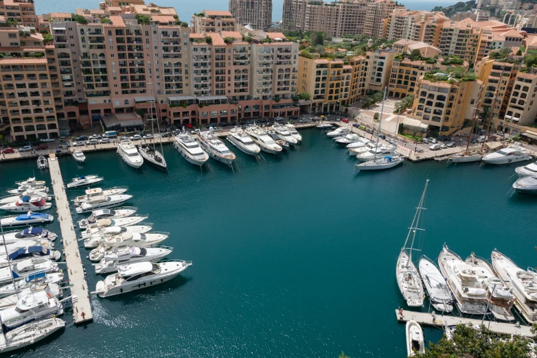 many boats in the water near tall buildings