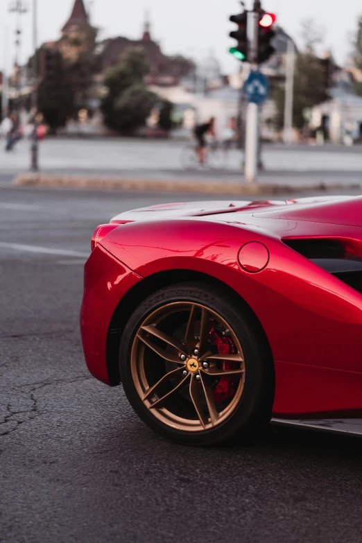 a red sports car is parked on a side street