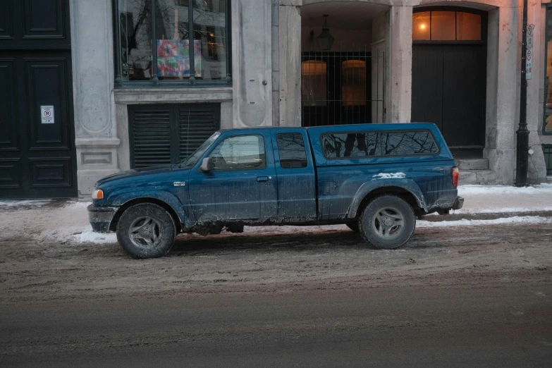 the truck is parked along the side of the building