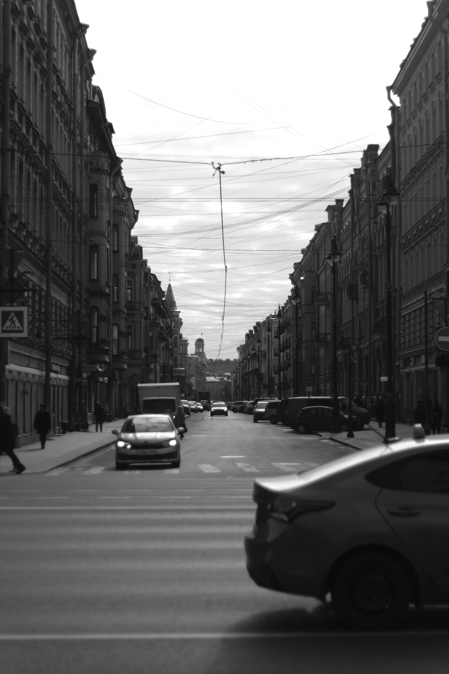 a busy street in the city with cars and people