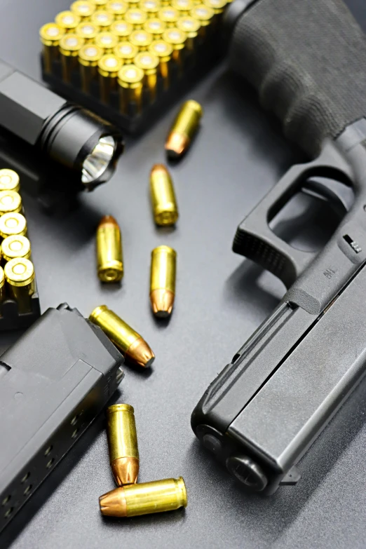 some shooting magazines and guns on top of a counter