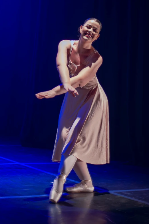a beautiful young woman wearing a dress while dancing