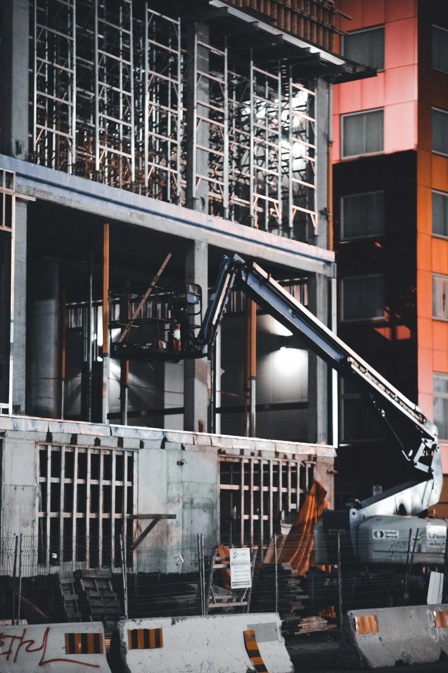 a large crane standing in front of a tall building