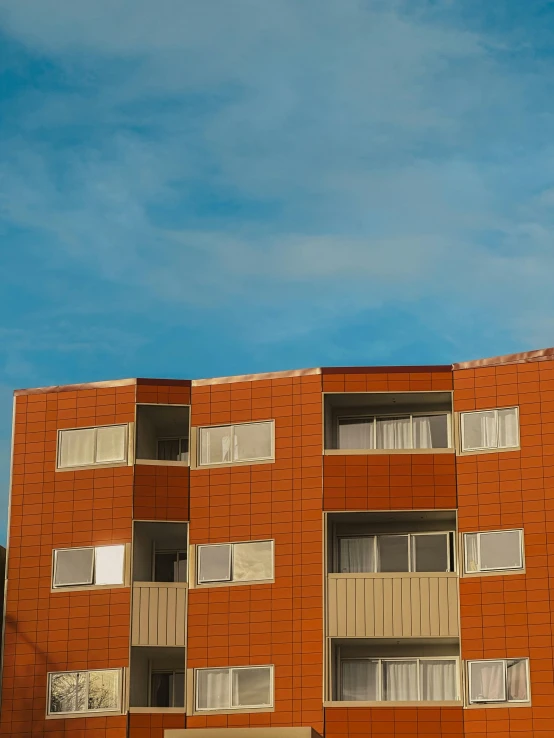 the tall building has many windows and balconies on it