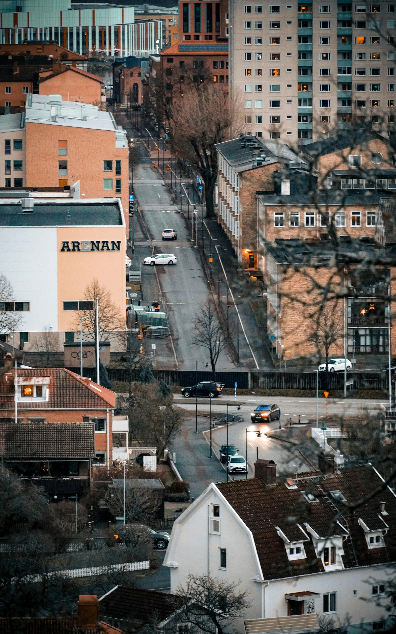 an urban area with many buildings and a few cars parked