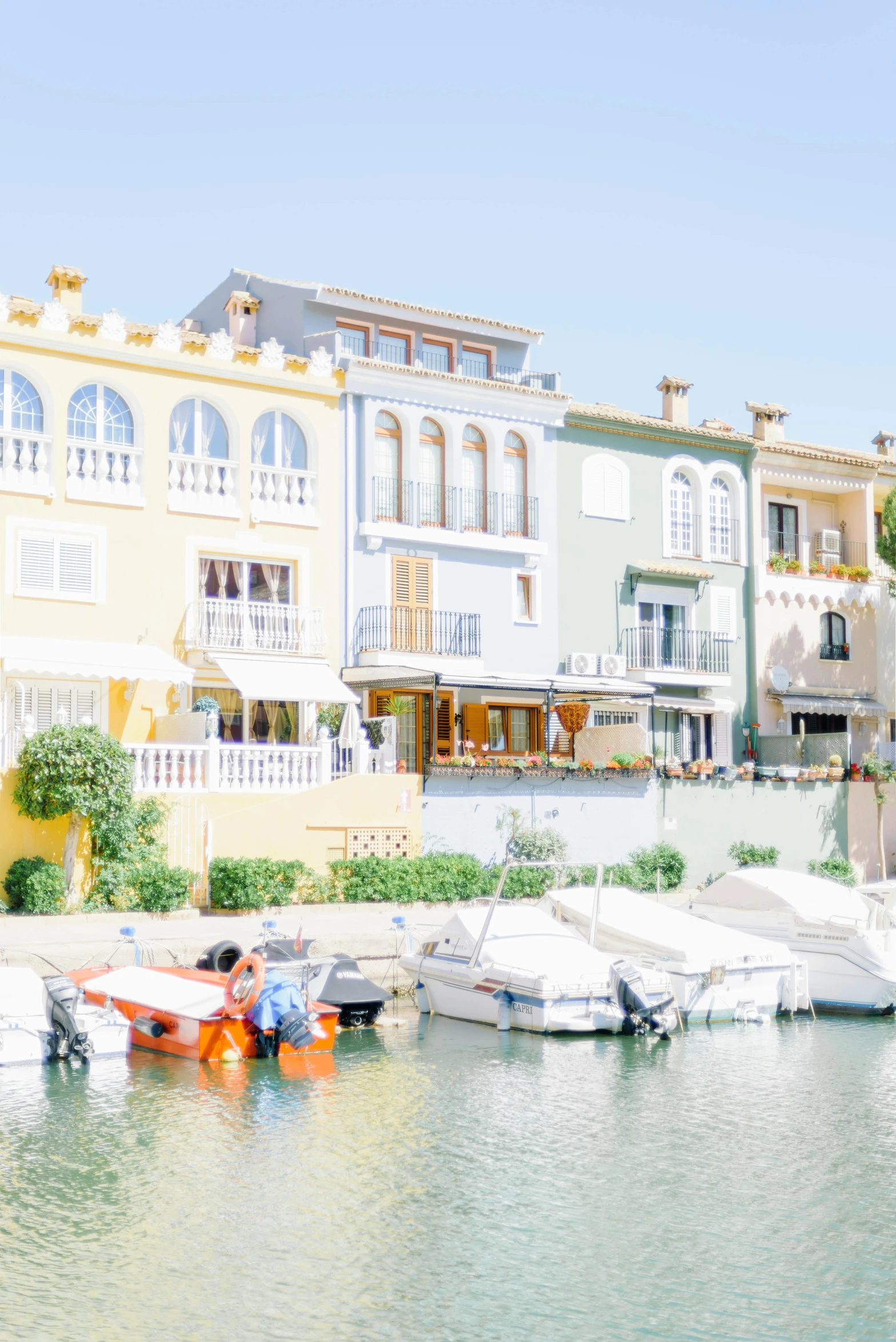 there are many boats docked in the harbor by many buildings