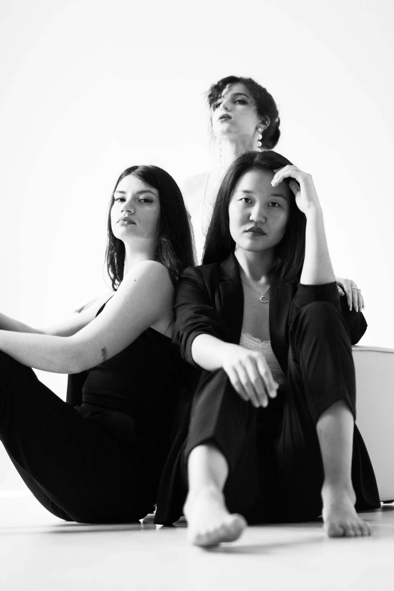 three women sit in an area and practice yoga