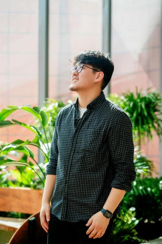 a person standing by some plants in a room